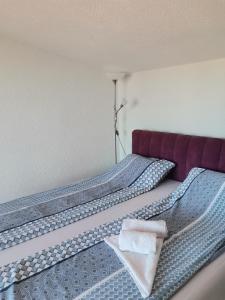 a hotel room with two beds with towels on them at Jelly Apartment in Visoko
