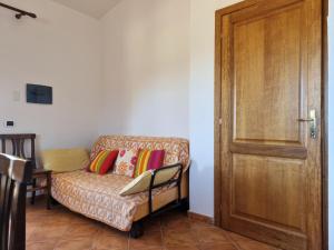 ein Wohnzimmer mit einem Sofa und einer Holztür in der Unterkunft Residenze Pedrame in Budoni