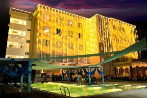 a large building with a playground in front of it at Clarks Resort Birgunj in Bīrganj