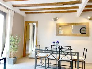 a dining room with a glass table and chairs at Top Barcelona Apartments in Barcelona