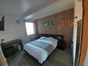 Postel nebo postele na pokoji v ubytování Hotel Au Spatial