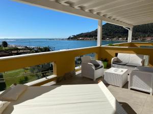 a balcony with chairs and a view of the ocean at Maison Del Magra in Ameglia