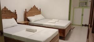 Postel nebo postele na pokoji v ubytování Rabang Traveller's Inn