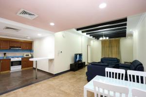 a living room with a couch and a table at Pearl Bahrain WLL in Manama