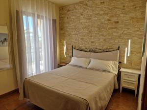 Postel nebo postele na pokoji v ubytování Masseria Casale Dei Fornici + 37 fotografií