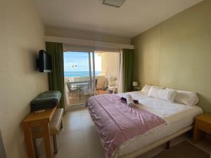 a bedroom with a bed and a view of the ocean at BENALBEACH COMPLEX in Benalmádena