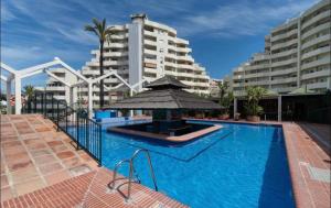 a swimming pool in front of some tall buildings at BENALBEACH COMPLEX in Benalmádena