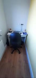 an office with a desk and a blue chair at Swan Studio Haven in Lisdoonvarna