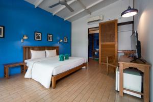 a bedroom with a bed and a television and a desk at The Stage-Koh Chang in Ko Chang +42 photos