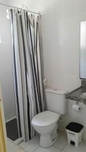 a white bathroom with a toilet and a shower at Refugio na Serra 2 in Bananeiras