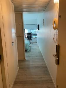 a hallway with a phone on the wall at Maipo 1501 in Buenos Aires