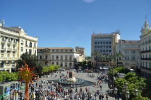 a crowd of people walking around a plaza in a city at SunShine Capricho de las Tendillas in Córdoba