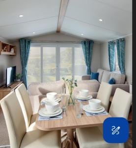 a dining room with a table and chairs at Beauview Brand New For 2023 Wi-Fi and Smart TV in Millom