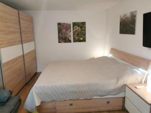 a bedroom with a bed and two pictures on the wall at Guesthouse Stivan (920) in Cres