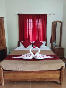 a bedroom with a bed with two rings on it at Jungle Villa Munnar in Pooppara