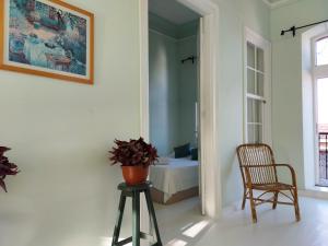 a room with a chair and a table and a bed at Eolos House Cunda in Ayvalık