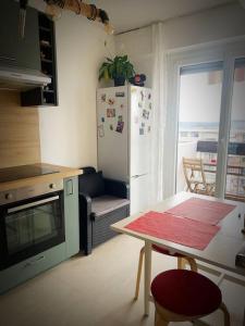 a kitchen with a table and a refrigerator at T1 bel appartement proche de Genève in Annemasse
