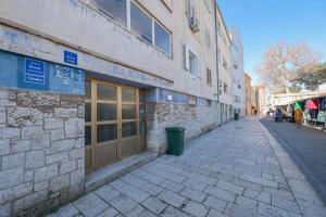 an empty street in front of a building at Rooms lopwi Old town Ground floor in Zadar