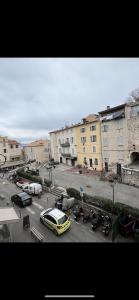 a yellow car parked in a parking lot with buildings at Coeur du Vieil Antibes in Antibes