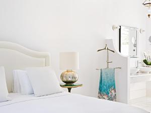 A bed or beds in a room at Caramel, A Grecotel Resort to Live