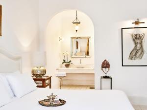 A bed or beds in a room at Caramel, A Grecotel Resort to Live