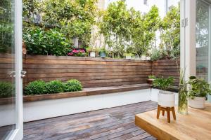a porch with a wooden fence and plants at Beautiful Kensington flat in London