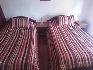 two beds sitting next to each other in a room at Firma lfassiya in Dar SaÃ¯d Ben Hajj