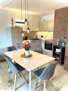 a kitchen and dining room with a table and chairs at Appartment 2015 in Tossens in Tossenserdeich