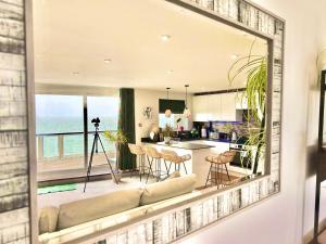 a kitchen and living room with a view of the ocean at Stunning Sea View Two Bed Apartment - With Balcony in Bournemouth