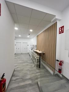 a hallway of an office with a table and chairs at CH TANEZ CAROLINA a in Madrid