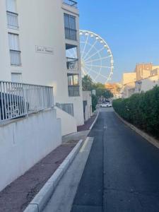 una calle vacía con una noria en el fondo en Joli T2 Centre port résidence Quai d'Honneur, en Cap d'Agde