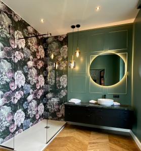 a bathroom with a sink and a mirror at Georgi Schloss - Boutique Hotel in Ehrenhausen