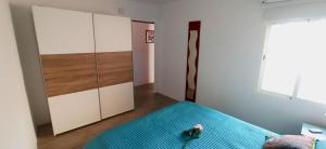 a bedroom with a bed with a blue blanket at Siesta in Hospitalet de l'Infant