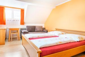 a bedroom with a bed and a chair in it at Binderhof in Weisspriach