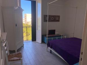 a bedroom with a bed and a laptop on a table at casa del parco vista mare in Trapani