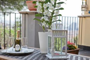 a table with a bottle of champagne and a vase with flowers at B&B La Veduta in Naples
