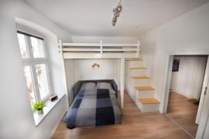 a bedroom with a bunk bed and a staircase at Apartmenthaus Fritz Reuter in Schwerin