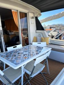 a table and chairs on the deck of a yacht at Giorgia House Boat in Palermo