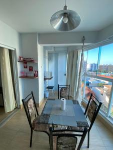 a dining room with a table and chairs and a window at Apartamento no Fiori Prime in Caldas Novas
