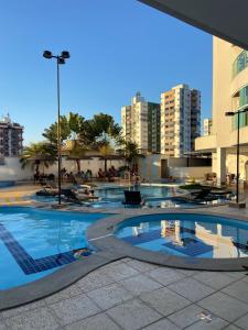 a large swimming pool in a city with buildings at Apartamento no Fiori Prime in Caldas Novas