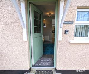a green door with a sign in front of it at The Paddock in Killyleagh