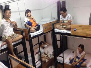 a group of people sitting in bunk beds at Starfish Alley Hostel in Da Nang