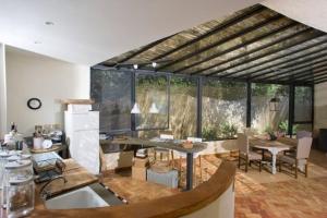 a kitchen and living room with a table and chairs at La casa nella Macchia in Monte Argentario