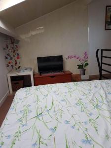 een slaapkamer met een bed met een bloemenbed bij Bassussarry in Bassussarry