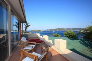 a balcony with chairs and a view of the water at No81 Hotel in Golturkbuku