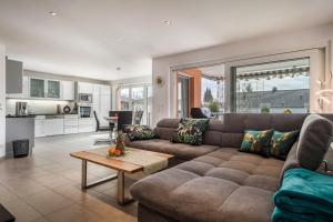 a living room with a couch and a table at Haus Birkengraben in Hard