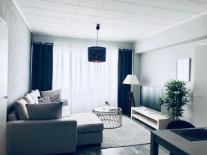 a living room with blue curtains and a couch at Kotimaailma Pori City in Pori