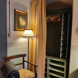 a lamp and a chair in a room with a closet at Villa I Bossi in Arezzo