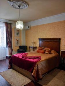 a bedroom with a large bed and a chandelier at Herdade da Fonte Ferreira in Avis