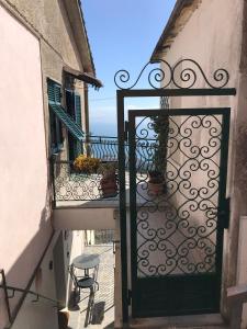 an open door to a balcony with a table and chairs at casa fiorella in San Bernardino